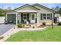 Inviting single-story home featuring a cozy front porch and beautifully landscaped yard at 15324 Sw 40Th Place Rd, Ocala, FL 34481