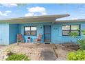 Charming front porch featuring rocking chairs, offering a relaxing outdoor space at 17128 Se 140Th Ave, Weirsdale, FL 32195