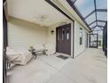 Comfortable screened-in porch featuring a ceiling fan and seating area at 3021 Beard Rd, The Villages, FL 32163