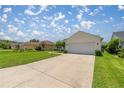 Well-maintained home with a spacious driveway, lush green lawn and mature landscaping at 3024 Burbank Ln, The Villages, FL 32162