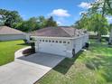 Charming home features a well-maintained lawn, long drive way and an attached two-car garage at 4085 Ne 17Th Ave, Ocala, FL 34479