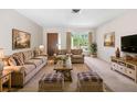 Cozy living room with plush furniture, decor, and ample natural light at 4467 Sw Channel Heights Ct, Dunnellon, FL 34431