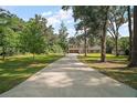 Long driveway leads to this lovely home surrounded by mature trees and lush greenery at 4673 Se 115Th St, Belleview, FL 34420