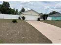 Charming single-story home featuring a two-car garage and a well-maintained front yard at 4704 Sw 138Th Loop, Ocala, FL 34473