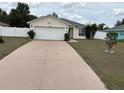 Charming single-story home featuring a two-car garage and a well-maintained front yard at 4704 Sw 138Th Loop, Ocala, FL 34473