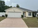 Charming single-story home featuring a two-car garage and a well-maintained front yard at 4704 Sw 138Th Loop, Ocala, FL 34473