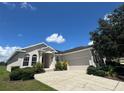 Well maintained one story home featuring a low-pitched roof, arched windows, and a manicured lawn at 4940 Sw 63Rd Loop, Ocala, FL 34474