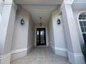 Inviting front door framed by stylish columns and decorative sconces at 4940 Sw 63Rd Loop, Ocala, FL 34474