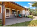 Inviting front porch with wood columns and furniture, perfect for outdoor seating at 5005 Ne 22Nd Ave, Ocala, FL 34479