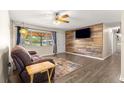 Comfortable living room with wood accent wall and laminate floors at 5005 Ne 22Nd Ave, Ocala, FL 34479