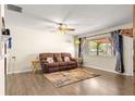 Spacious living room featuring a ceiling fan and ample natural light from the window at 5005 Ne 22Nd Ave, Ocala, FL 34479