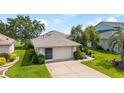Charming single story home with a well-manicured lawn and 2 car garage at 5007 Kelso St, Leesburg, FL 34748