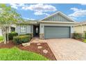 Charming single-story home with a brick driveway, well-manicured landscaping, and a two-car garage at 5651 Nw 40Th Pl, Ocala, FL 34482