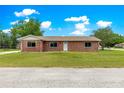 A single-story brick home with a well-manicured front yard and inviting curb appeal at 6989 Se 52Nd Pl, Ocala, FL 34472