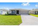 Attractive home with a well-kept lawn and spacious driveway leading to the garage at 7203 Sw 86Th Ave, Ocala, FL 34481