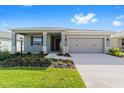 Charming home with a landscaped yard, covered entry, and attached two car garage at 7203 Sw 86Th Ave, Ocala, FL 34481