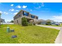 Well-maintained two-story home featuring a manicured lawn and an expansive driveway at 8142 Sw 59Th Ave, Ocala, FL 34476