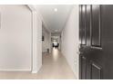 Bright hallway featuring neutral walls and tile flooring offering a glimpse into the home's layout at 8142 Sw 59Th Ave, Ocala, FL 34476