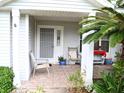 Charming front porch with tiled floor, comfortable seating, and a welcoming entrance at 8321 Sw 108Th Place Rd, Ocala, FL 34481