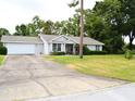 A single story home is shown with an attached garage and long driveway at 8321 Sw 108Th Place Rd, Ocala, FL 34481