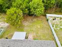 Aerial shot of a spacious backyard with a shed and greenery, perfect for outdoor activities at 9 Bahia Trace Loop, Ocala, FL 34472
