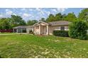 Single-story home with a well-maintained lawn and a detached garage visible at 9 Bahia Trace Loop, Ocala, FL 34472