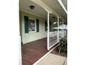 Cozy front porch with painted wood floors and white railing at 9622 Se 71St Ct, Ocala, FL 34472