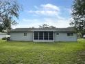The rear of the house shows a screened in porch and spacious backyard at 11248 Sw 76Th Ter, Ocala, FL 34476