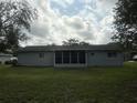 Simple single story home features a screened-in back porch and a large backyard at 11248 Sw 76Th Ter, Ocala, FL 34476