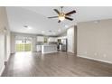 Open-concept living room and kitchen featuring stainless steel appliances and luxury vinyl flooring at 17277 Sw 44Th Cir, Ocala, FL 34473