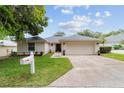 Charming single-story home with a well-manicured lawn, attached garage, and a freshly painted exterior at 2644 Sw 20 Cir, Ocala, FL 34471