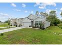 Beautiful home with large lawn, garden and two car garage at 32 Hickory Course Loop, Ocala, FL 34472