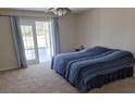 Bright bedroom with French doors leading to the outside and carpet flooring at 360 Marion Oaks Golf Way, Ocala, FL 34473