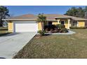 Charming yellow single-Gathering home with well-maintained landscaping and a spacious driveway at 360 Marion Oaks Golf Way, Ocala, FL 34473