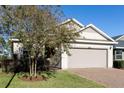 Charming single-story home featuring a two-car garage and manicured front lawn with a brick-paved driveway at 3947 Nw 46Th Ter, Ocala, FL 34482