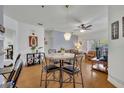 Bright dining area with hardwood floors, a table for four, and decorative accents at 4897 Cypress Wood Dr # 6313, Orlando, FL 32811