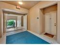 Neutral hallway with the unit's front door and a doorway to a stairway at 4897 Cypress Wood Dr # 6313, Orlando, FL 32811