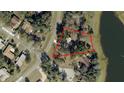 Aerial view of a home in a neighborhood setting, surrounded by trees, with the property outlined in red at 519 Spring Lake Rd, Ocala, FL 34472