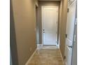 Hallway with tile flooring and neutral paint, creating a seamless transition between living spaces at 5255 Nw 33Rd Pl, Ocala, FL 34482