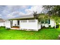 A home backyard with a private, partially enclosed patio and a well maintained lawn at 6190 Sw 84Th Pl, Ocala, FL 34476