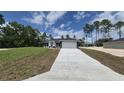 Inviting single-story home with a long driveway and attached two-car garage at 717 Marion Oaks Mnr, Ocala, FL 34473