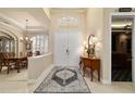 Inviting foyer with an elegant rug, a view into the dining room and easy access to theater at 7915 Se 12Th Cir, Ocala, FL 34480