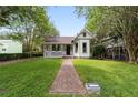Charming home featuring a brick walkway, landscaped yard and welcoming front porch at 828 Se 3Rd St, Ocala, FL 34471