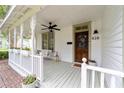Inviting porch with a porch swing, flower boxes, and a stained wood front door at 828 Se 3Rd St, Ocala, FL 34471