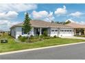 Beautiful single-story home with a well-manicured lawn, three-car garage, and lush landscaping at 9886 Sw 104Th Ave, Ocala, FL 34481