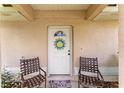 Close-up of a white front door with a sun-shaped wreath and welcome mat at 106 Pine Trce, Ocala, FL 34472