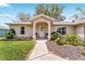 Inviting front entrance featuring a covered porch and decorative landscaping at 106 Pine Trce, Ocala, FL 34472