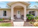 Close-up of the front entrance with chairs and a decorative wreath at 106 Pine Trce, Ocala, FL 34472