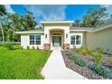 Inviting home entrance with stone accents, manicured landscaping, and a lovely walkway leading to the front door at 130 Nw 113Th Cir, Ocala, FL 34482