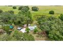 An aerial view of a property showing the home, surrounding trees, and expansive greenery at 22535 Sw 117Th St, Dunnellon, FL 34431